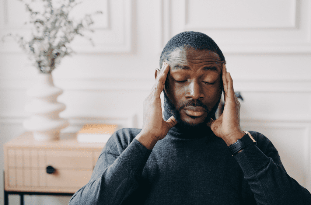 person with headache stressed and supplements to lower cortisol