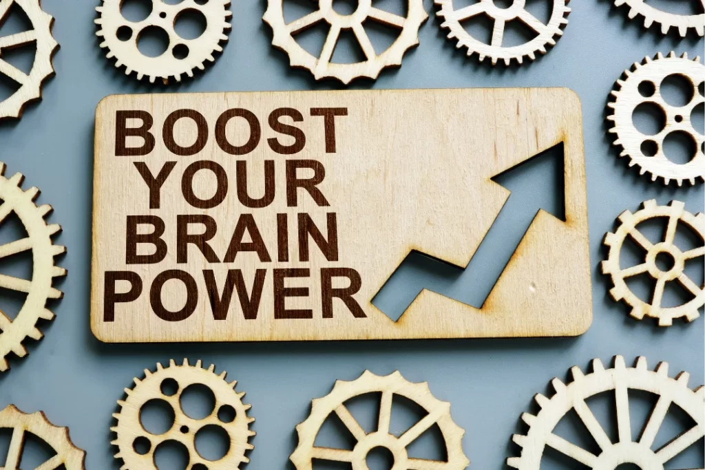 Boost your brain written on a wooden piece with wooden gears at a side
