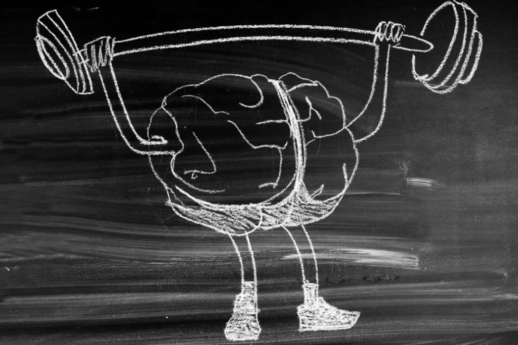 Brain sketch doing exercise on black board with chalk.