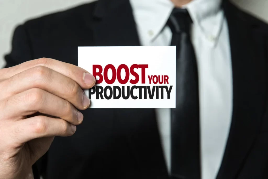 Boost your productivity written on white paper in a man's hand.