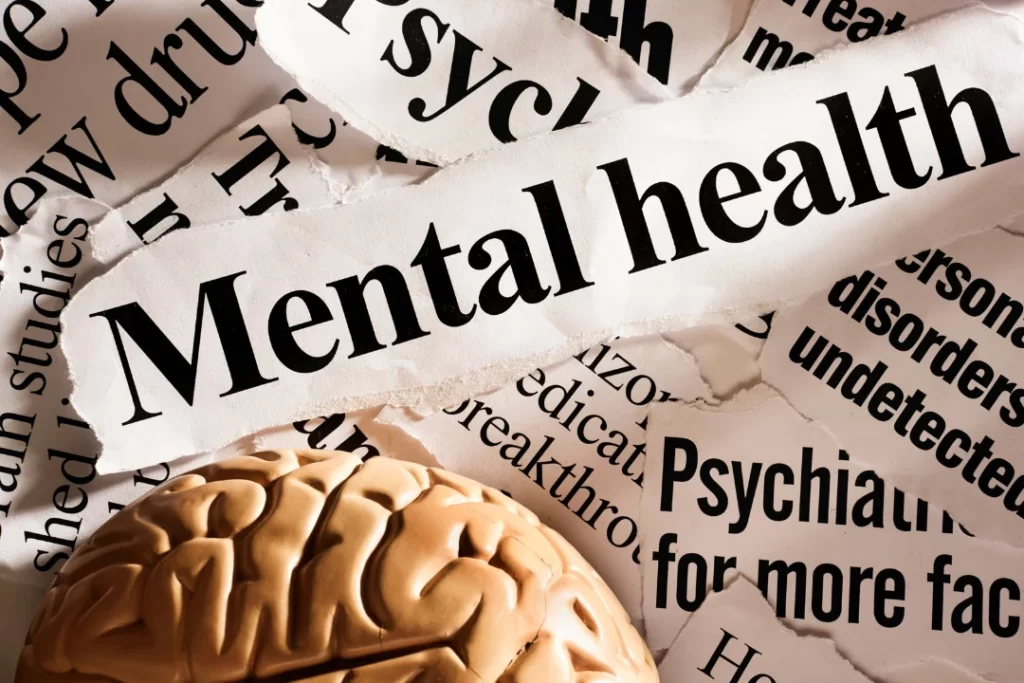 mental health is written on white paper with brain aside