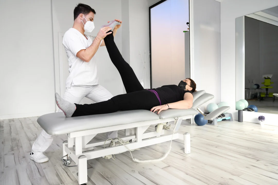 Doctor treating patient suffering from sciatic nerve pain