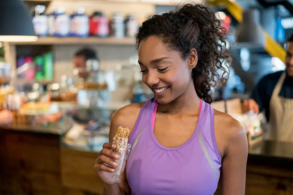 Woman eating protein bar
