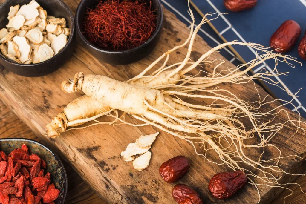 Organic fresh ginseng on kitchen wooden board.
