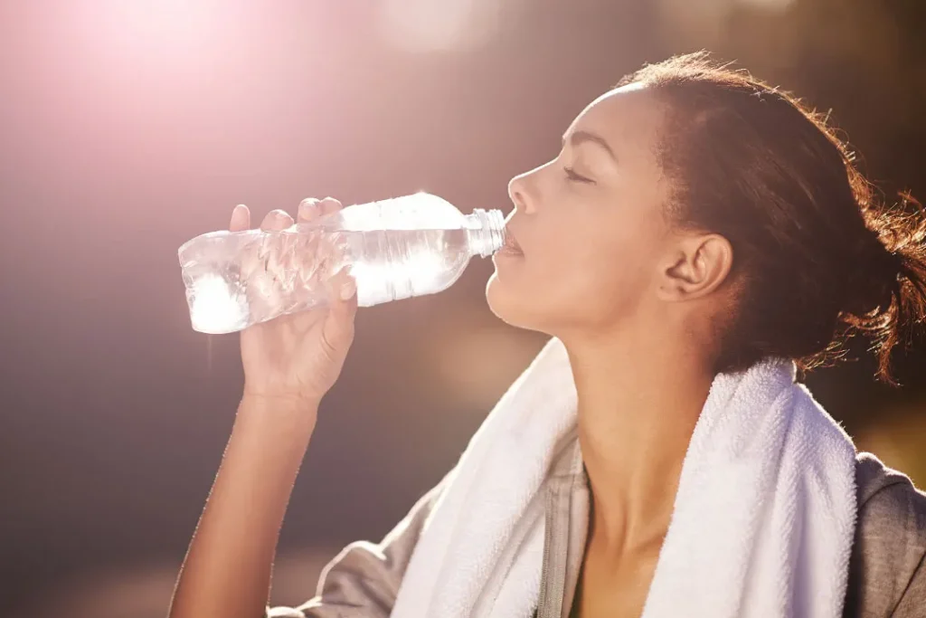 close up shot of a young woman drinking water