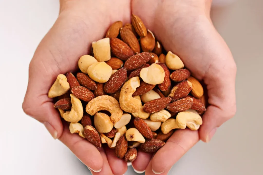 nuts closeup shoot in hand 
Nature's garden keto snack mix