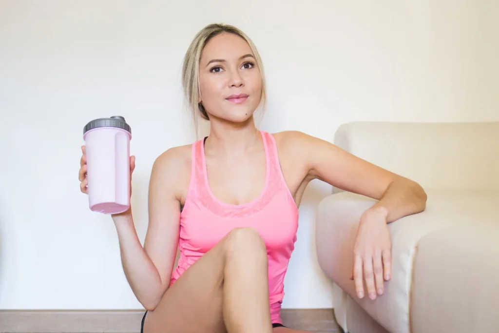 Lady having protein drink.