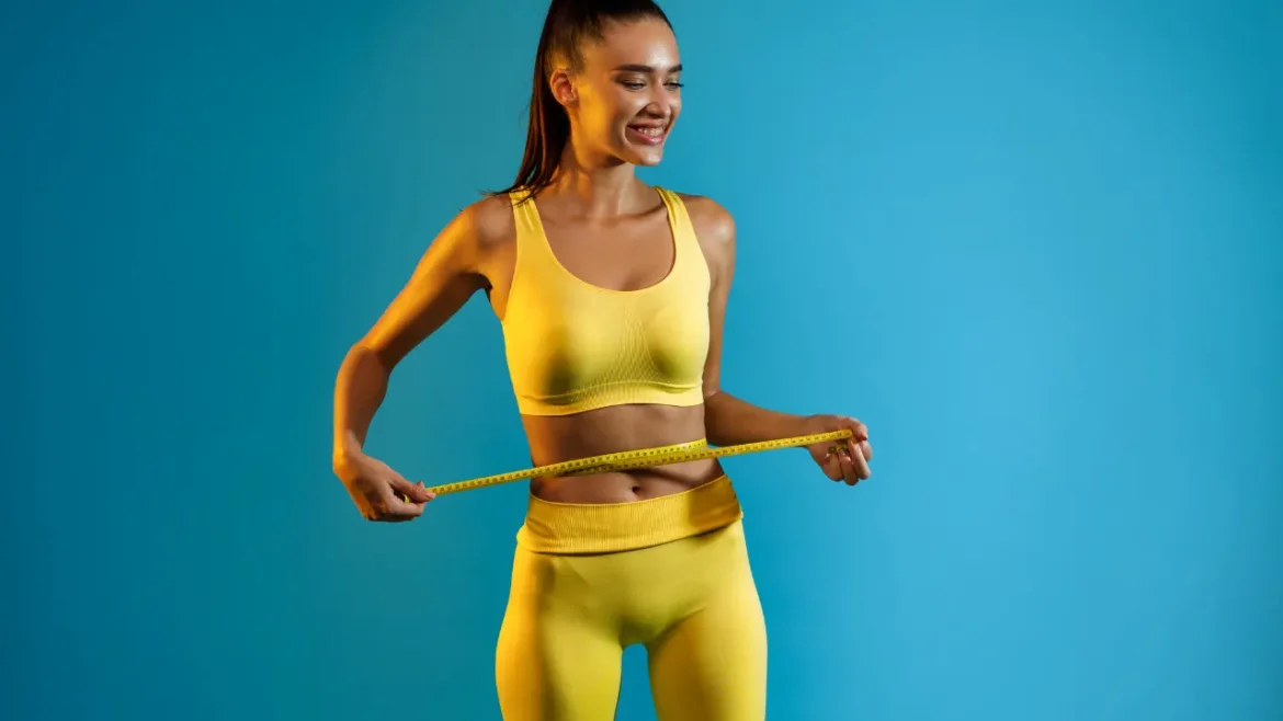 Slim girl with measuring tape around her waist