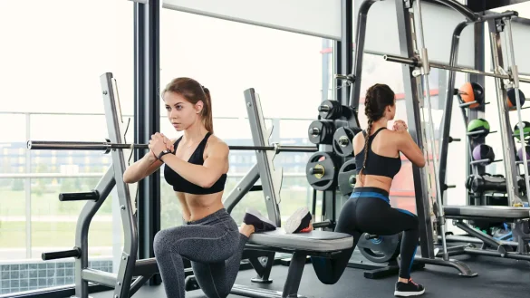 Slim and fit gilrs working out in gym