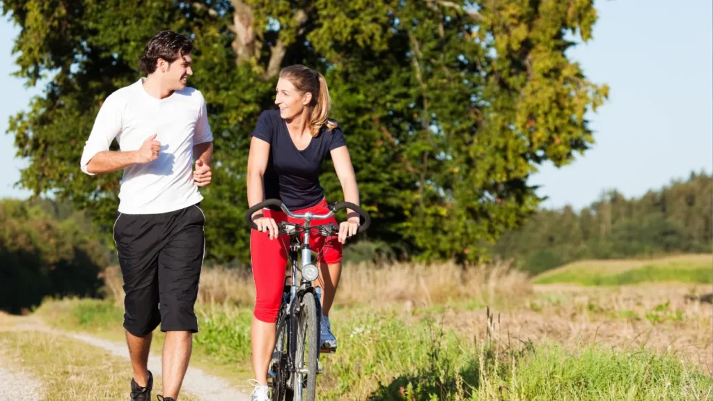 Young couple jogging and cycling